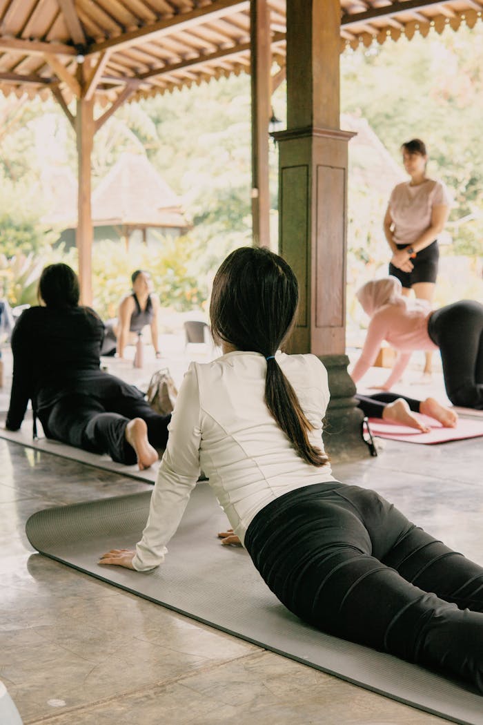 Outdoor yoga session in Jawa Barat, Indonesia featuring diverse participants practicing in tranquility.